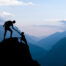 Teamwork couple climbing helping hand